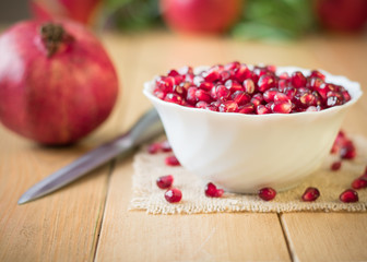 Still life with fresh pomegranate on a wooden table.
