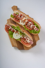 sandwich with sausage and vegetables isolated