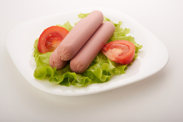 sausages with vegetables on a white background