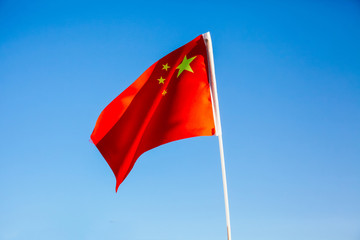 China flag waving over blue sky - country in Asia