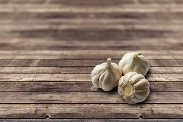 Garlic on vintage light brown color wood texture background