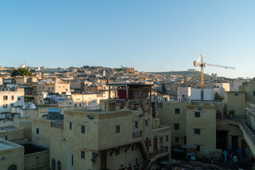 Fototapeta premium Tanners working leather in the old tannery of Fes, Morocco 