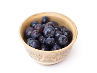 blueberries in a bowl on a white background