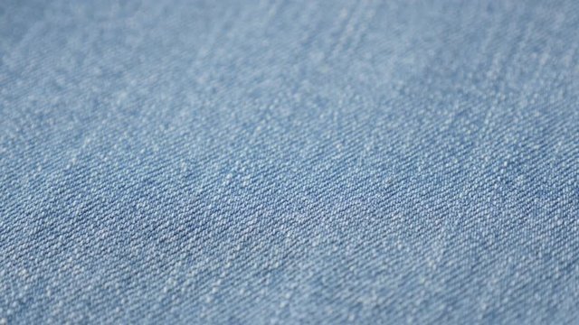Blue weathered denim surface close-up 4K 2160p 30fps UltraHD tilting footage - Classic jeans texture details slow tilt shallow DOF 3840X2160 UHD video 