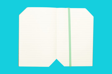 Note book on blue background isolated