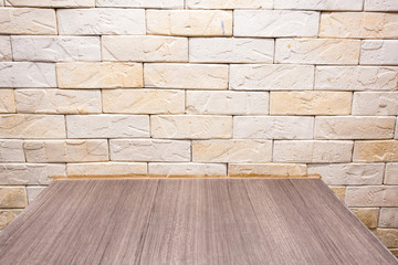 Brown yellow brick with wooden table background