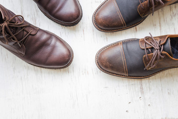 Men's brown leather shoes on white rustic wooden background, beauty and fashion concept