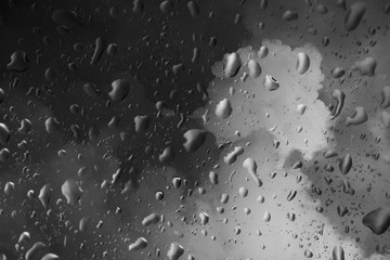 Blurry of storm cloud ,view through the window on rainy day.