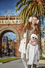 Obraz premium happy mother and daughter near Arc de Triomf in Barcelona, Spain