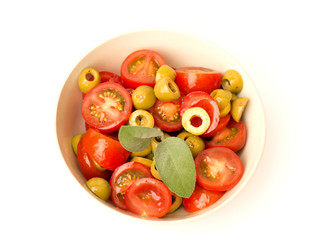 salad with olives and tomatoes in a bowl on a white background