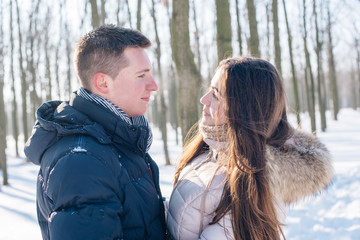 young loving couple having fun in snowy park
