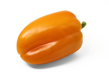 Orange bell peper in horizontal position on white background