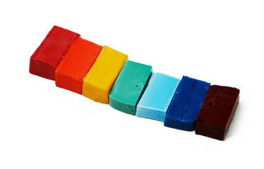 Smalt tiles of different colors arranged in rainbow order on whi