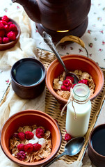 Breakfast for two. Black tea and muesli. Food located on a wicke