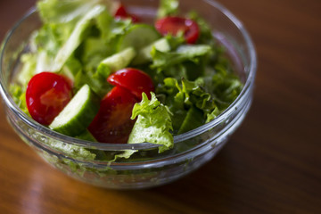 Green healthy salad with little tomatoes and salad leaves.