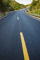Fototapeta na wymiar Infinity curved road with yellow line. Concept of adventure, travel, success...