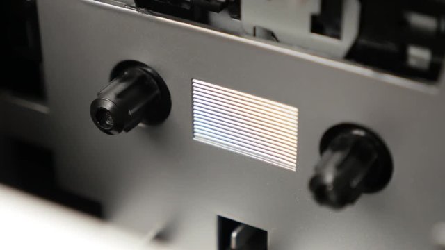 Compact cassette recording device shallow DOF 3840X2160 UltraHD footage - Close-up of supply spindle rotates on music tape playing mechanism 2160p UHD video