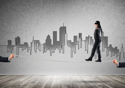 Business concept of risk support and assistance with man balancing on rope