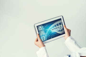 Close of female doctor hands working with tablet pc computer