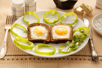 Healthy breakfast with toasted bread and eggs with cup of tea and milk.