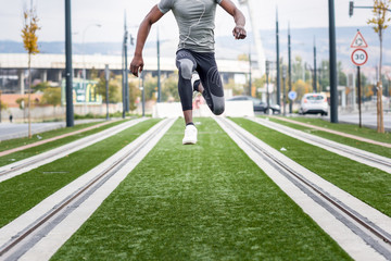 Attractive black man running in urban background