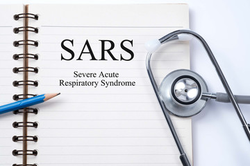 Stethoscope on notebook and pencil with SARS (Severe Acute Respi