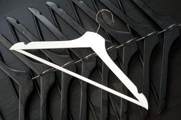 White hanger and a few black hangers, background, abstract
