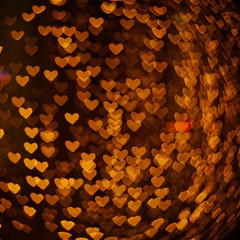Abstract orange bokeh in a form of heart