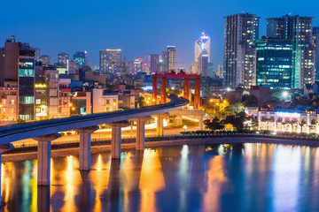 Aerial view of Hanoi cityscape by twilight period, with Dong Da lake and under construction Cat...