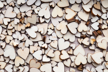 Wooden hearts, one red heart on the heart background.
