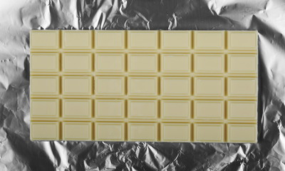 white chocolate bars isolated on aluminum foil 