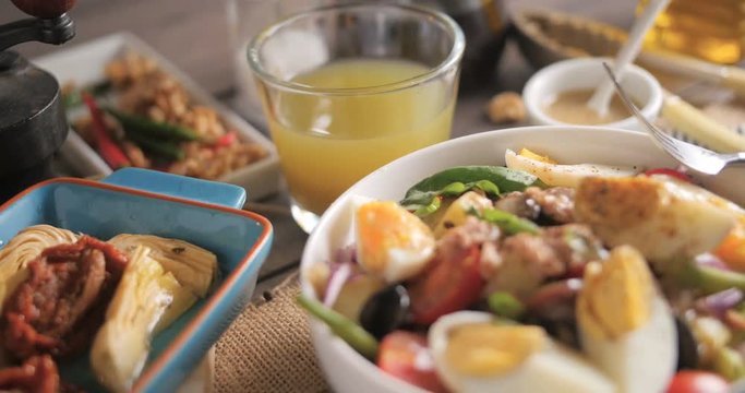 Dolly revealing view of a fresh, healthy, organic nicoise salad