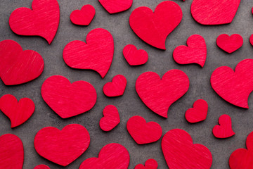 Red hearts on the wooden background.