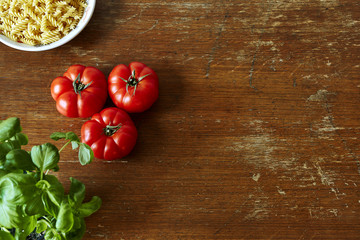 rich kitchen scene with tomatoes herbs and pasta