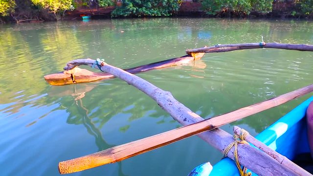 Sailing with a pirogue on indian river, Goa, India