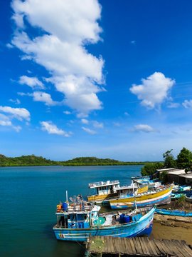Beautiful Colorful Boats in Fishing Village by the Lagoon with Mangroves Blue sky and Clouds near Pulmoddai, Trincomalee, Sri Lanka