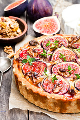 Delicious  tart with fresh figs and goat cheese on rustic wooden