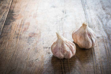 Organic garlic whole and cloves on the wooden