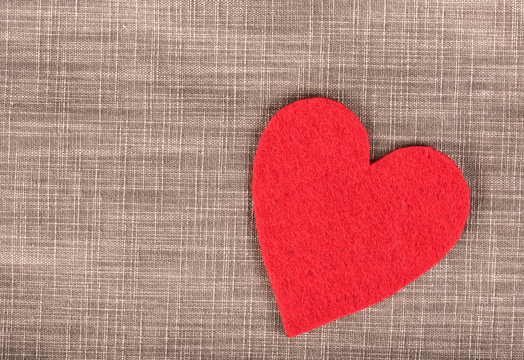 Red heart shape on a fiber background