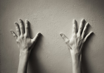 Hands up! Hands against the wall concept. 