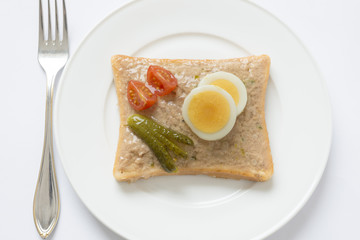 Snack. Sandwich with tuna, eggs, tomatoes, pickled cucumber covered with jelly.