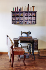 a grouping of antique sewing equipment in a room