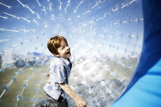 Cheerful boy in Zorb ball