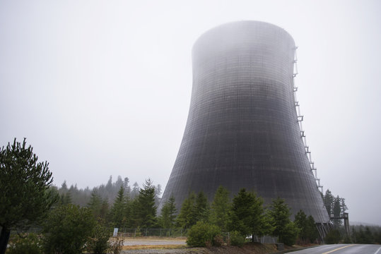 Low angle view of nuclear reactor in foggy weather against sky