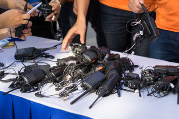 Portable walkie talkies on table with man hands