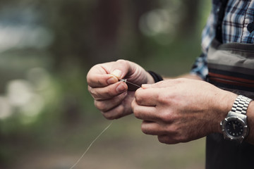 Close up of man holding fishing thread 