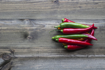 Colorful cayenne chili peppers on wooden table.
