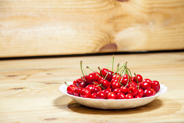 Red cherry in plate.