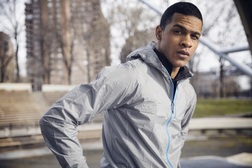 Portrait of confident male athlete standing at park