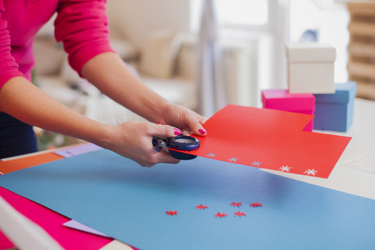Young woman make scrapbook of the papers on the table using anti
